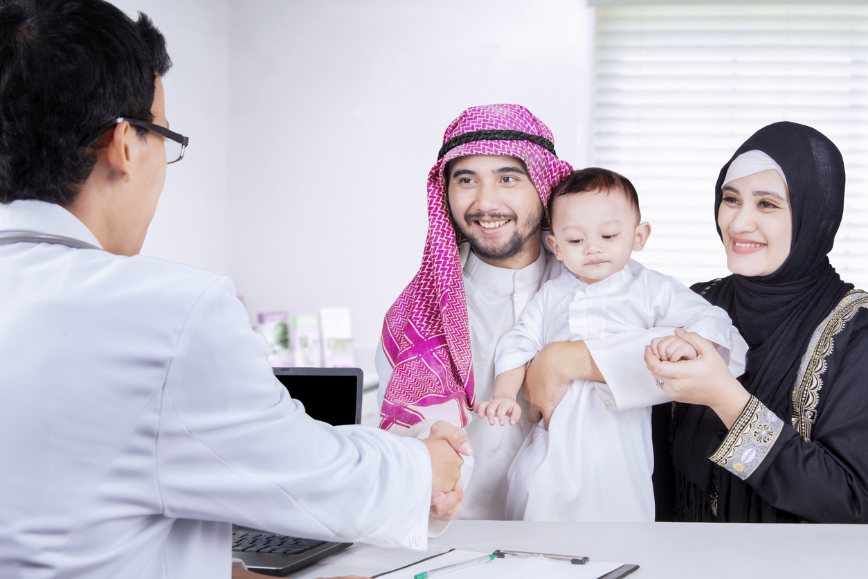 Family shaking hands with pediatrician in the clinic